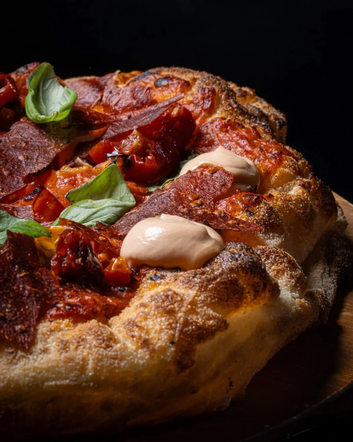 Wood-fired pizza with tomato, creamy burrata and fresh basil at Francesco Martucci