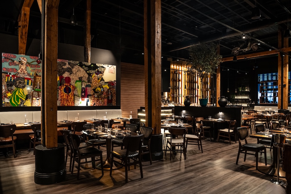 Warm industrial dining room with wood tables in Wynwood